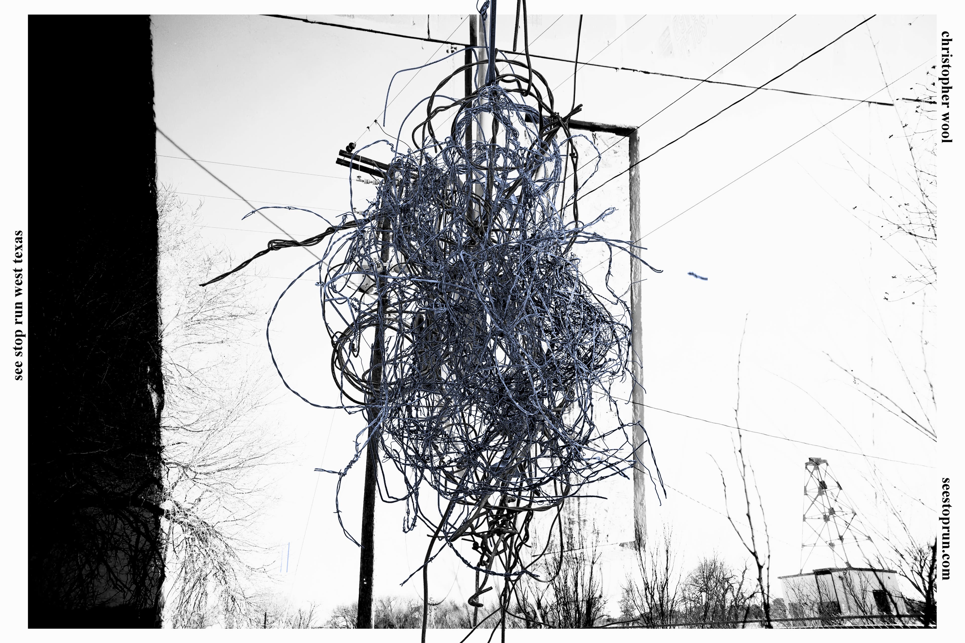 A two-tone image of a horizontally oriented exhibition poster. Blue woodgrain textures are superimposed on a black and white shot of two sets of plywood steps and a rough table leaning against the exterior of a building.